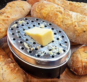 Double food grater, for coarse & fine, grating, plus storage container, lid & cleaning brush.